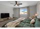 Bright bedroom featuring a comfortable bed and a large TV at 2523 Villageview Ln, Castle Rock, CO 80104