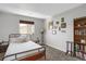 Cozy bedroom with a bookshelf and window seating area at 2523 Villageview Ln, Castle Rock, CO 80104