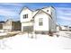 Two-story home with white siding, gray accents, and a snowy front yard at 2523 Villageview Ln, Castle Rock, CO 80104