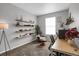 Bright home office with floating shelves, a large window, and comfortable seating at 2523 Villageview Ln, Castle Rock, CO 80104