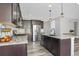 Modern kitchen with dark cabinetry, granite countertops, and a spacious island at 2523 Villageview Ln, Castle Rock, CO 80104