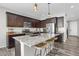 Modern kitchen with dark cabinets, granite countertops, and stainless steel appliances at 2523 Villageview Ln, Castle Rock, CO 80104