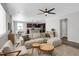 Open concept living room and kitchen with hardwood floors, neutral decor, and ceiling fan at 2523 Villageview Ln, Castle Rock, CO 80104