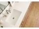 Close-up of bathroom sink with modern fixtures, white countertop, and jute rug adding texture and warmth at 2738 N Clay St, Denver, CO 80211