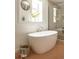 Elegant bathroom featuring a freestanding soaking tub and separate glass-enclosed shower at 2738 N Clay St, Denver, CO 80211