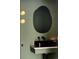 Stylish bathroom features a unique mirror, modern lighting, and sleek fixtures at 2738 N Clay St, Denver, CO 80211