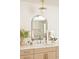 Stylish bathroom vanity with a modern arched mirror, pendant light, and light wood cabinets at 2738 N Clay St, Denver, CO 80211