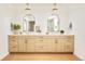 Bathroom showcasing double vanity sinks with modern fixtures and unique terra-cotta colored flooring at 2738 N Clay St, Denver, CO 80211