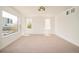 A spacious bedroom with large windows offers ample natural light, highlighting the neutral carpet and modern fixture at 2738 N Clay St, Denver, CO 80211