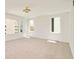 A spacious bedroom with large windows offers ample natural light, highlighting the neutral carpet and modern fixture at 2738 N Clay St, Denver, CO 80211