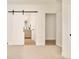 Open bedroom with barn door leading to a bathroom offering a glimpse of modern living and design at 2738 N Clay St, Denver, CO 80211