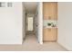 Modern hallway with a built-in storage cabinet featuring light wood doors and a white countertop at 2738 N Clay St, Denver, CO 80211