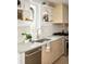 Close up of bright kitchen with white tile backsplash, stainless steel appliances, and open shelving at 2738 N Clay St, Denver, CO 80211