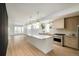 Bright, open kitchen with a large island, stainless steel appliances, and hardwood flooring at 2738 N Clay St, Denver, CO 80211