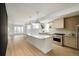 Bright kitchen with quartz countertops, stainless steel appliances, light wood floors, and open shelving at 2738 N Clay St, Denver, CO 80211