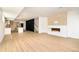 Open living space with kitchen, fireplace, hardwood floors, and modern staircase at 2738 N Clay St, Denver, CO 80211