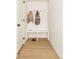 Cozy mud room with a bench, coat hooks, and light wood flooring; perfect for organizing your everyday essentials at 2738 N Clay St, Denver, CO 80211