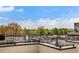 Wide view of rooftop decks with black railings and lush trees visible on the horizon at 2738 N Clay St, Denver, CO 80211