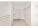 Well-organized walk-in closet with white shelving, rails, and neutral carpeting at 2738 N Clay St, Denver, CO 80211