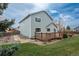 A well-maintained backyard with a deck and stone path leading to the house at 23955 Glenmoor Way, Parker, CO 80138