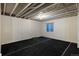 Unfinished basement featuring concrete ceiling with visible piping and black carpeted floor at 23955 Glenmoor Way, Parker, CO 80138