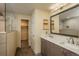 Bathroom with dual sinks, a large mirror, and a glass enclosed walk-in shower at 23955 Glenmoor Way, Parker, CO 80138
