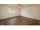 Bedroom with hardwood floors, a ceiling fan, and natural light from the large window at 23955 Glenmoor Way, Parker, CO 80138