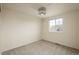 A neutral bedroom with a large window showing a view of neighborhood homes at 23955 Glenmoor Way, Parker, CO 80138