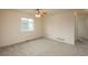 Well-lit bedroom featuring neutral walls, carpeting, ceiling fan, and a window with neighborhood view at 23955 Glenmoor Way, Parker, CO 80138