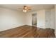 Primary bedroom with hardwood floors, a ceiling fan, and ensuite bathroom with glass shower at 23955 Glenmoor Way, Parker, CO 80138