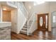 Inviting foyer with hardwood floors, staircase, and decorative front door at 23955 Glenmoor Way, Parker, CO 80138
