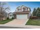 Charming two-story home with stone accents, a well-maintained lawn, and a two-car garage at 23955 Glenmoor Way, Parker, CO 80138