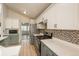 Modern kitchen featuring white cabinets, stainless steel appliances, and tile backsplash at 23955 Glenmoor Way, Parker, CO 80138