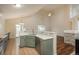 Bright, open kitchen with tile floor and backsplash, bar seating, and living area access at 23955 Glenmoor Way, Parker, CO 80138