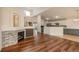 Open-concept living area with hardwood floors, fireplace, and view into the kitchen at 23955 Glenmoor Way, Parker, CO 80138