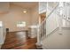 Bright living room with hardwood floors and high ceilings, featuring a staircase and fireplace at 23955 Glenmoor Way, Parker, CO 80138
