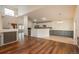 Spacious living area with hardwood floors, fireplace, and views of the kitchen and staircase at 23955 Glenmoor Way, Parker, CO 80138
