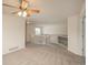 Bright loft area with neutral carpeting, ceiling fan, and staircase featuring white banister at 23955 Glenmoor Way, Parker, CO 80138