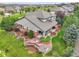Aerial shot of back yard featuring mature landscaping, custom patio with fire pit, and outdoor seating at 7949 S Blackstone Pkwy, Aurora, CO 80016