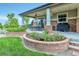 Outdoor patio area featuring dining seating, a grill, and landscaped brick planters at 7949 S Blackstone Pkwy, Aurora, CO 80016