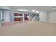 Finished basement featuring light blue walls, neutral carpet and luxury vinyl flooring, and a kitchenette at 7949 S Blackstone Pkwy, Aurora, CO 80016
