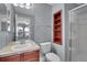 Updated bathroom featuring a single sink vanity, a convenient shower, and integrated shelving for toiletries at 7949 S Blackstone Pkwy, Aurora, CO 80016