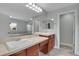 Bright bathroom with double sink vanity, large mirror, and access to the shower room at 7949 S Blackstone Pkwy, Aurora, CO 80016