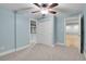 Neutral bedroom with carpet, ceiling fan, walk-in closet, and attached bathroom at 7949 S Blackstone Pkwy, Aurora, CO 80016