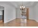 Bright dining room featuring hardwood floors, an elegant chandelier, and sliding glass doors to the outdoors at 7949 S Blackstone Pkwy, Aurora, CO 80016