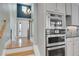 Entryway and staircase next to kitchen, featuring stainless appliances and modern design at 7949 S Blackstone Pkwy, Aurora, CO 80016