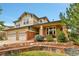 Charming home featuring brick accents, a covered porch, and a three-car garage at 7949 S Blackstone Pkwy, Aurora, CO 80016