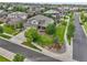 An aerial view of a house shows a well-maintained front yard, gardens, and a long driveway at 7949 S Blackstone Pkwy, Aurora, CO 80016