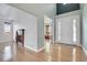 Bright foyer with light wood floors, a fireplace view, and elegant front door with sidelights at 7949 S Blackstone Pkwy, Aurora, CO 80016