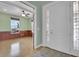 Entryway featuring light wood floors, decorative front door with sidelights, and view to adjacent office at 7949 S Blackstone Pkwy, Aurora, CO 80016